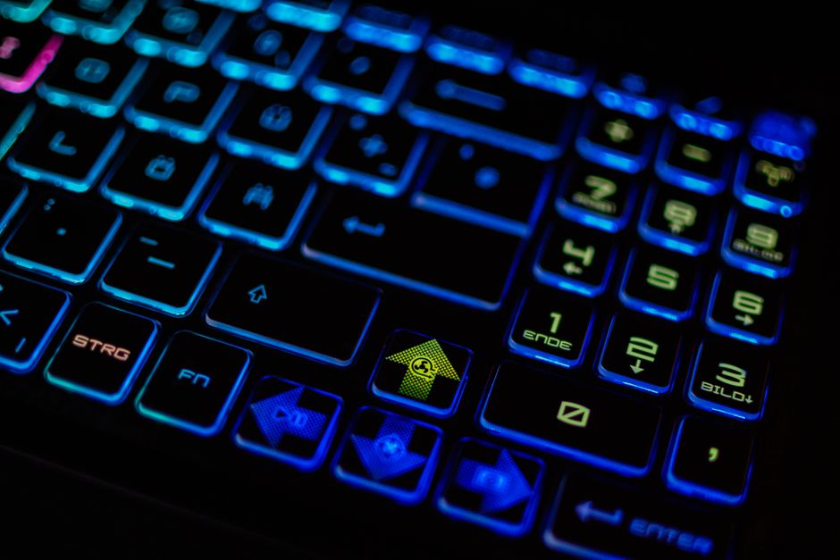 Close-up of a backlit RGB gaming keyboard, emphasizing vibrant colors and modern design.