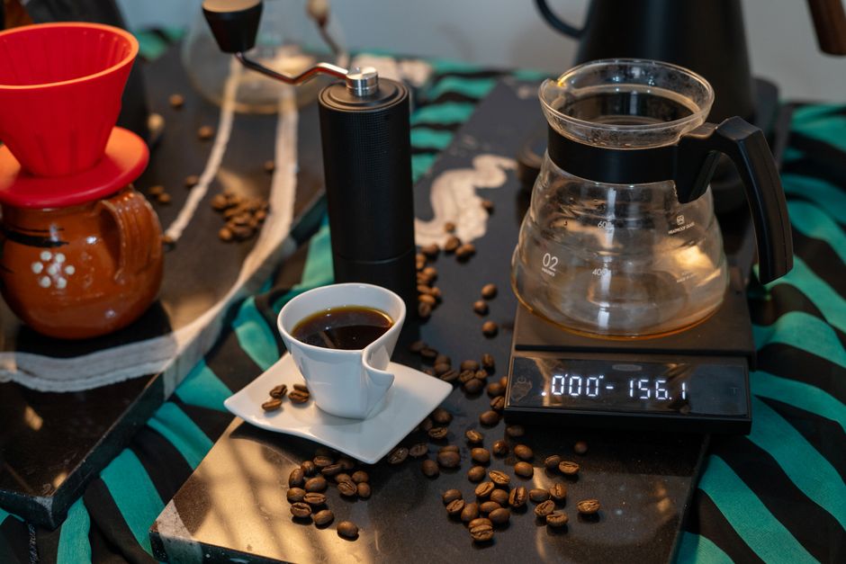 A complete coffee brewing setup featuring a precision scale and fresh coffee beans.