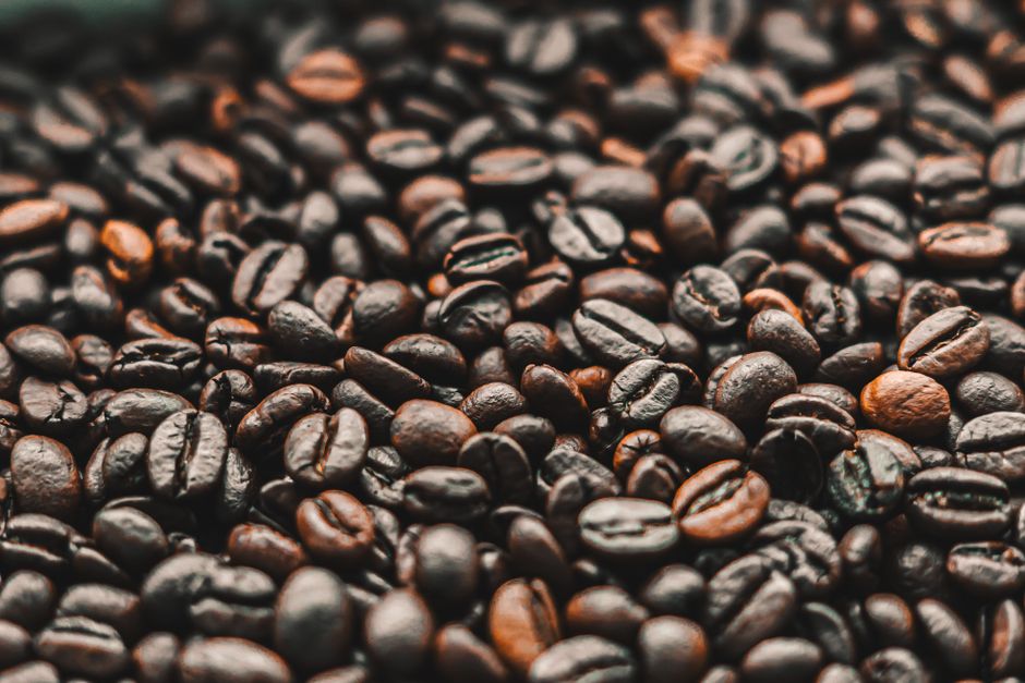 A detailed view of aromatic freshly roasted coffee beans perfect for beverages and gourmet cafes.